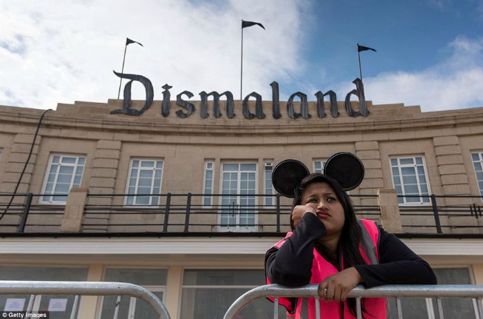 Employee looking bored at Banksy's Dismaland